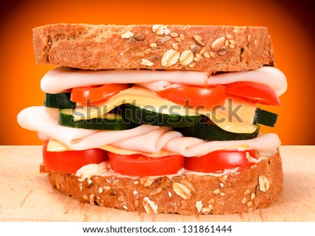 Big deli sandwich on the wooden board