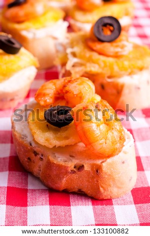 Selective focus on the front mini sandwich with shrimp and fried cheese