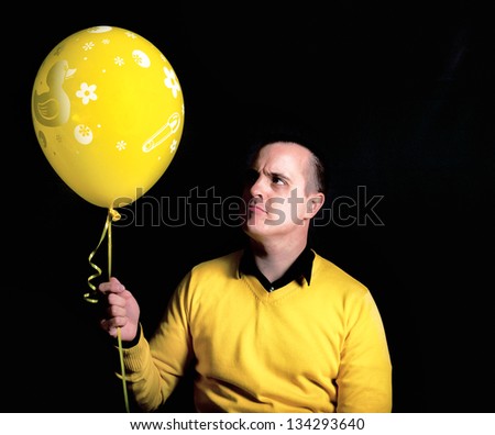 Man with yellow balloon. Shoot in low key technique