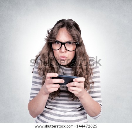 Angry female holding the mobil phone. Selective focus on the female