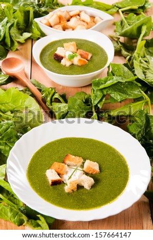 Cream homemade spinach soup. Selective focus on the front plate with soup
