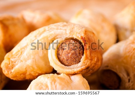 Fresh baked mini sausage rolls. Selective focus on the front sausage roll