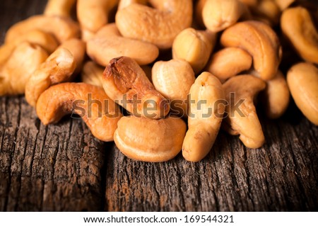 Close up to cashew nuts on the wooden table
