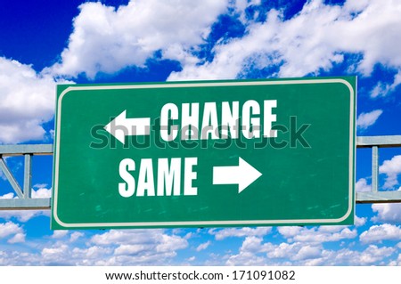 Change and same sign on the green board with clouds in background