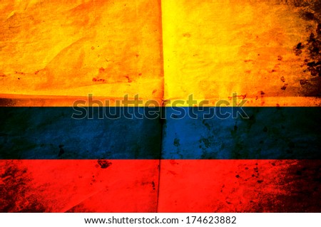 Old creased paper with Colombian flag as the background