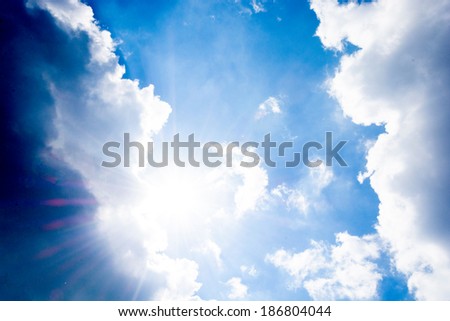 Light and dark clouds with strong sun in the middle
