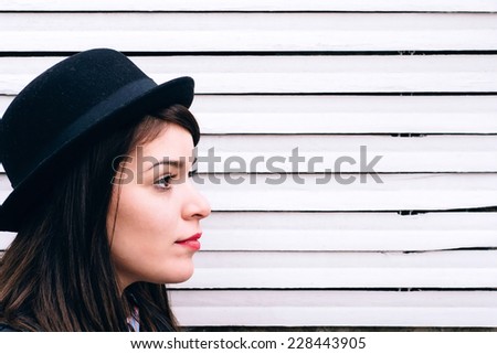 Portrait of female on white wooden background with blank space on the right side,selective focus