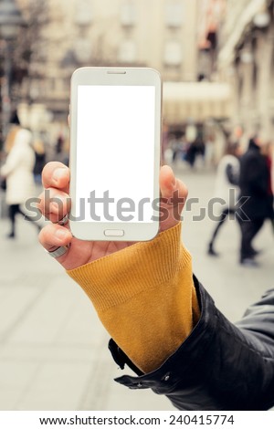 Blank white screen on the big mobile phone in man hands,selective focus