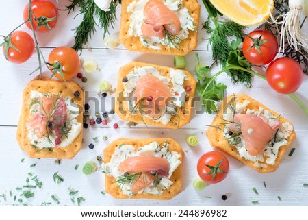Salmon sandwich appetizer on white wooden background