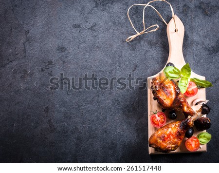 Chicken drumsticks with honey and spices on on wooden board,blank space on the left side