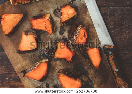 Slices of grilled pumpkin on the wooden background