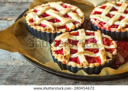 Traditional American pie stuffed with strawberries sweet sauce,selective focus
