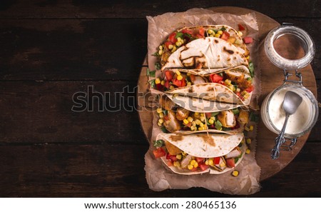 Tortilla sandwiches with fried chicken and vegetables,selective focus and blank space