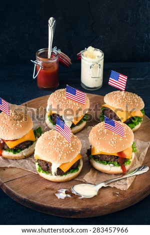 Ground beef mini burgers on wooden board,selective focus