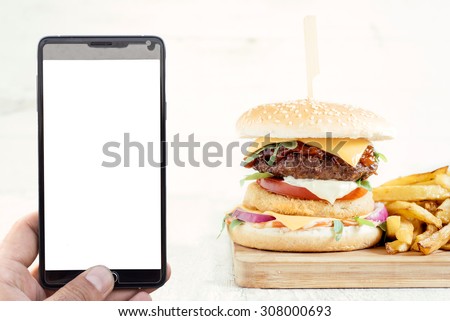 Order food concept with blank screen on smart phone and beef burger