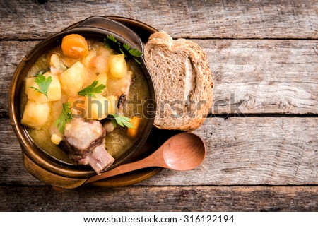 Homemade stew soup with vegetables and beef ribs in the rustic bowl,selective focus and blank space