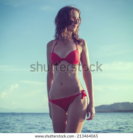 Outdoor summer outdoor portrait of young pretty woman girl standing in red bikini swimsuit