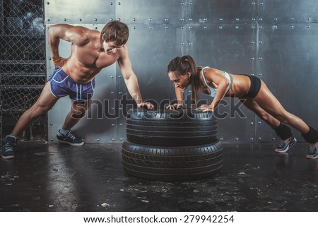 Sportswoman. Fit sporty woman doing push ups on tire strength power training concept crossfit fitness workout sport and lifestyle
