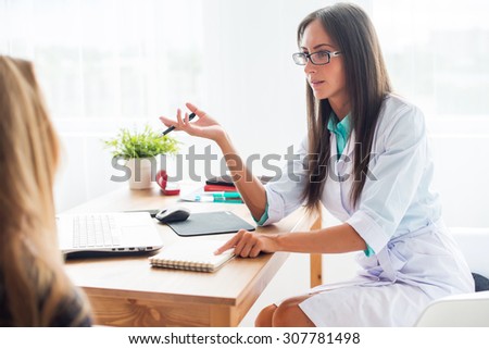 Medical physician doctor woman talking to patient sitting by the table