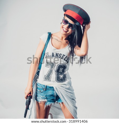 Fashion swag sexy girl holding gun woman having fun wearing police cap