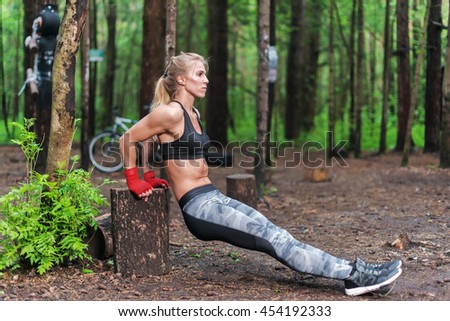 Similar – Image, Stock Photo Athletic woman doing triceps push-ups with a barbell plate