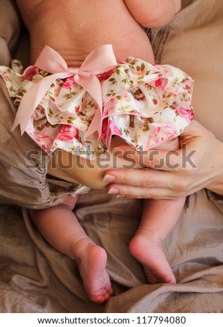 vertical orientation close up of a mother and baby girl in neutral colors / Mother and Child