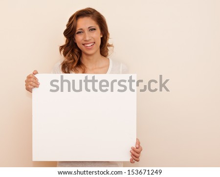 horizontal orientation of happy smiling teenage girl holding a blank, white, sign with copy space and neutral background / Pleased to Meet You!