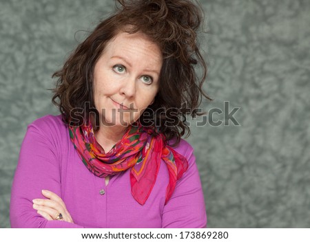 horizontal orientation of a woman in brightly colored business attire with a questioning look on her face and a crazy hair style with neutral background / Bad Hair Day