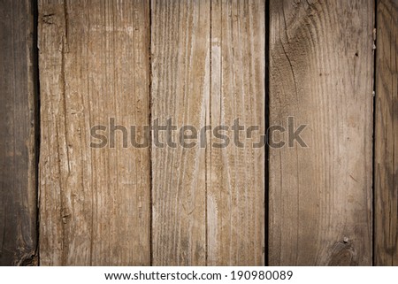 horizontal orientation close up of weathered wooden boards in a warm finish, as a background or texture, with copy space / Horizontal wooden boards