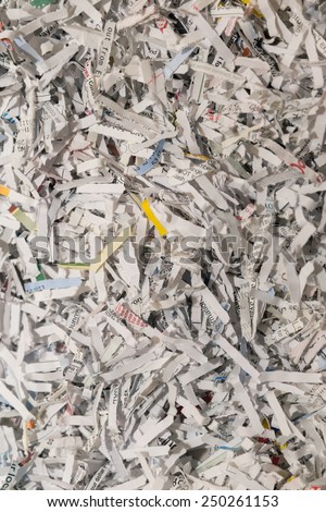 vertical orientation close up of shredded paper as a background, with copy space /  Paper Shred - Vertical