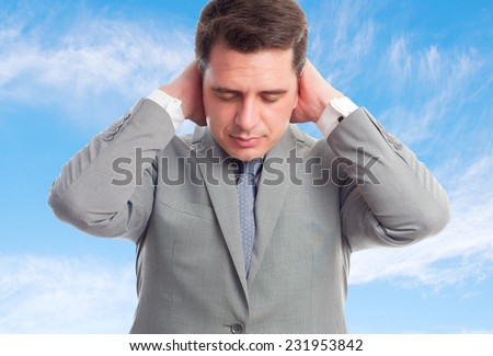Young business man with grey suit over clouds background. Looking tired