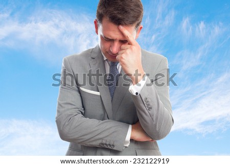 Business man with grey suit over clouds background. Looking tired