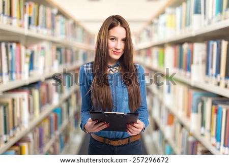 Trendy young woman holding a black folder. She looks confident. Over library background