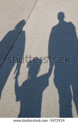 Shadow of a young family.  Mother, toddler and father.