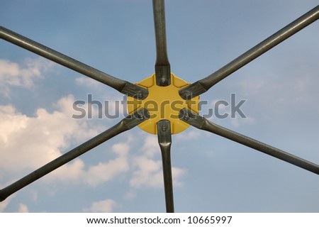 Closeup of a yellow joint on a geodesic dome.