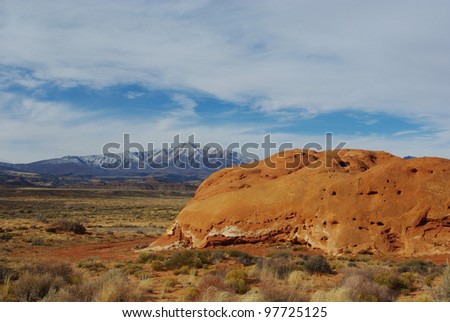 Red rock hill, highway, desert and Henry Mountains, Utah