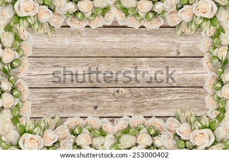 Wedding invitation with white roses on the wooden background