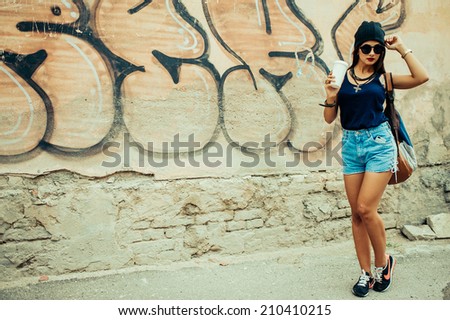 beautiful girl near the graffiti wall