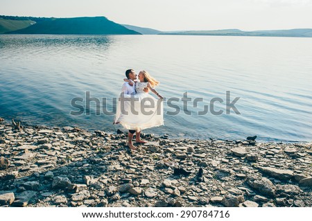 Young couple walk on sandy beach