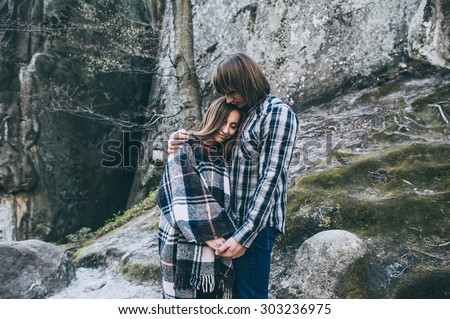 couple in love, walk on the rocks Dovbush Carpathian Mountains