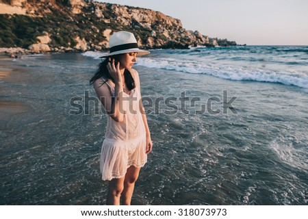 Caucasian woman walks along beautiful seashore