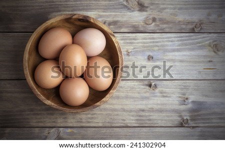 Similar – Image, Stock Photo Eggs in a bowl and baking ingredients on a kitchen table. Rustic.