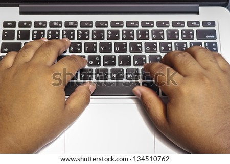 Close-up of typing male hands - Man\'s hands typing on laptop keyboard - hands typing on laptop