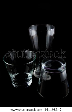Empty glasses for whiskey on a reflective surface on black background - Empty glasses on a black background