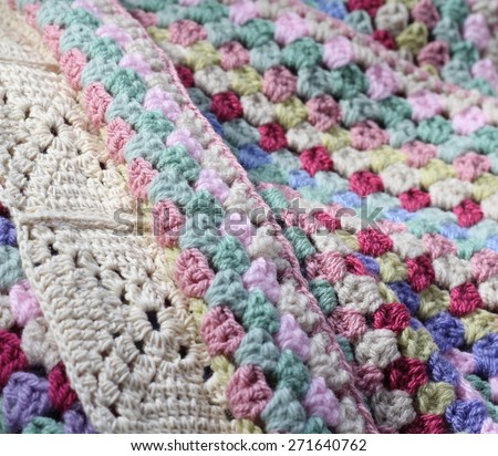 A pretty handmade crochet afghan wool blanket , details of different stitch types, vintage shades of creams, pinks, blues and green yarns, a craft and hobby