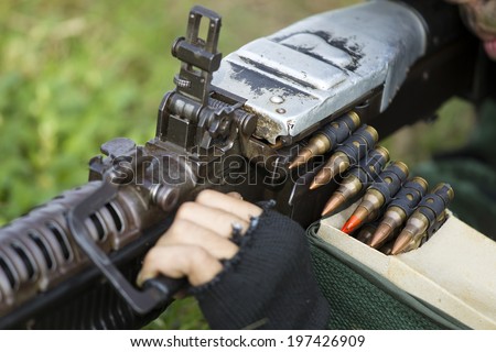 Soldier with the machine gun and ammunition