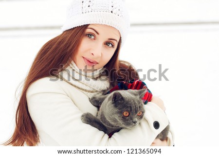 Young attractive woman with cat outdoors