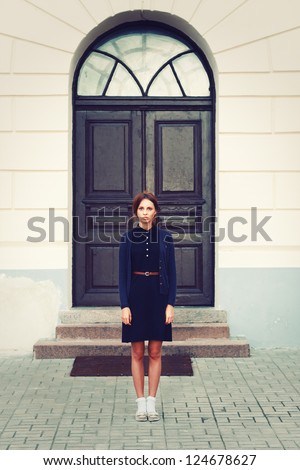 Outdoor vintage portrait of young attractive girl in retro clothing.