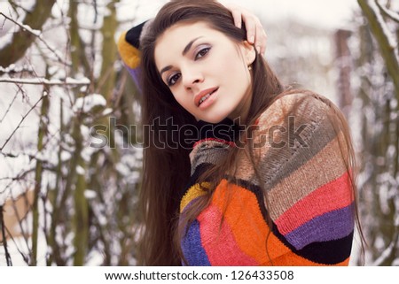 Outdoor winter portrait of young beautiful woman in winter. Pretty girl posing in spring park