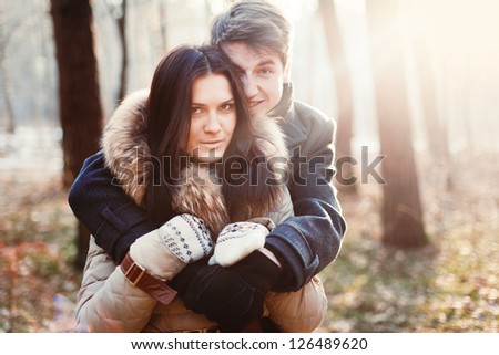 Young beautiful couple posing in cold spring forest